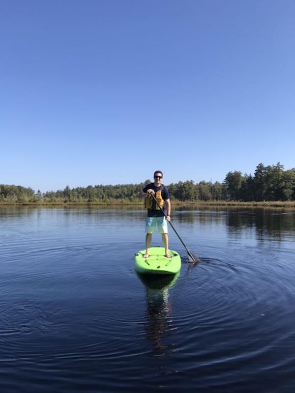 Jeremy enjoying standup paddle boarding on the lake