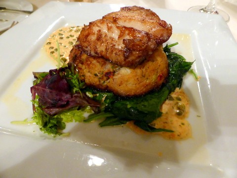 Exquisitely-cooked grouper sitting on a bed of crabcake and spinach