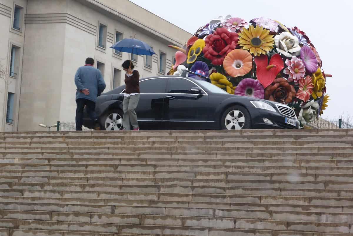 A tourist stops to see The Flower Sculpture on a Rainy Day (credit: Jerome Levine)