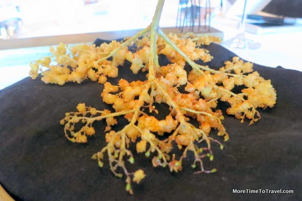 Delicately battered elderflower served on wood
