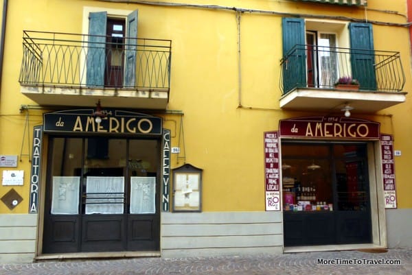The exterior of Amerigo 1934, the trattoria and dispensa (grocery), housed in a 3-story building on the main street of Savigno