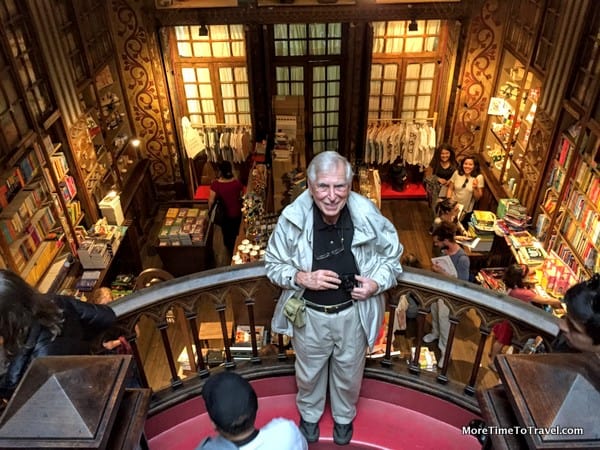 Stopping for a picture on a landing of the famous staircase in Livraria Lello