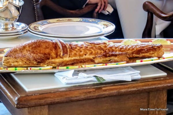 Sea bass stuffed in puff pastry shell with Choron sauce served tableside for two
