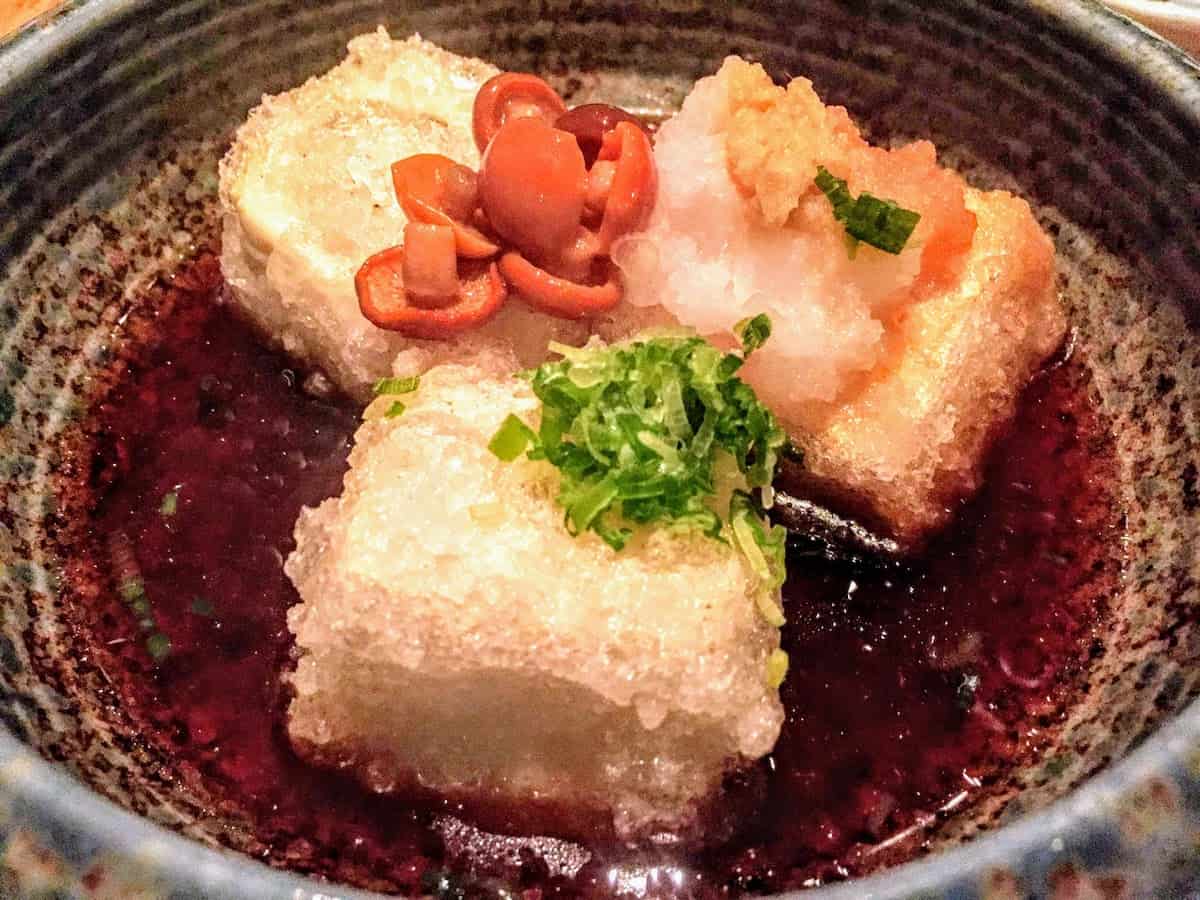 Agedashi Tofu, tofu coated in a light batter and deep-fried, served in a soy sauce infused broth