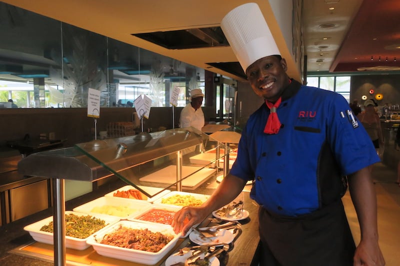 A chef proudly displays traditional Jamaican fare 