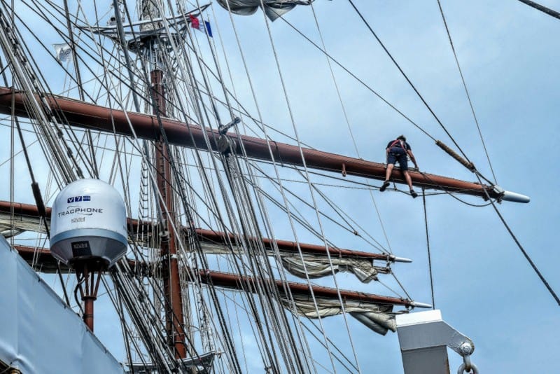 A crew member atop the mast on Sea Cloud