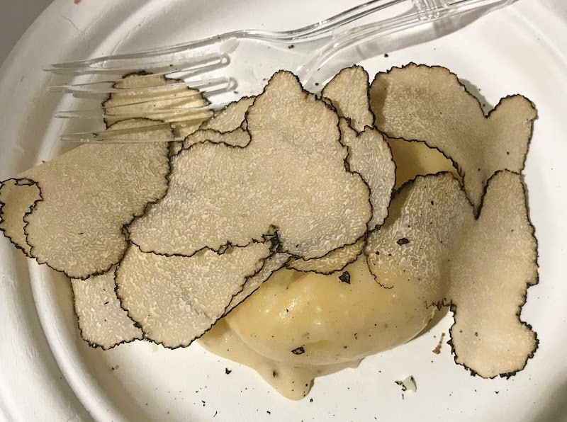 Serving of gnocchi garnished with white truffles