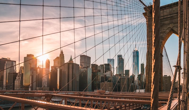 View of NYC thru Brooklyn Bridge (Credit: Unsplash)