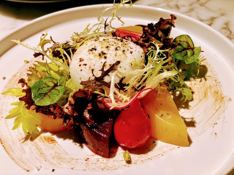 Burrata appetizer with fresh roasted beets, poached fruit and Sicilian pistachios
