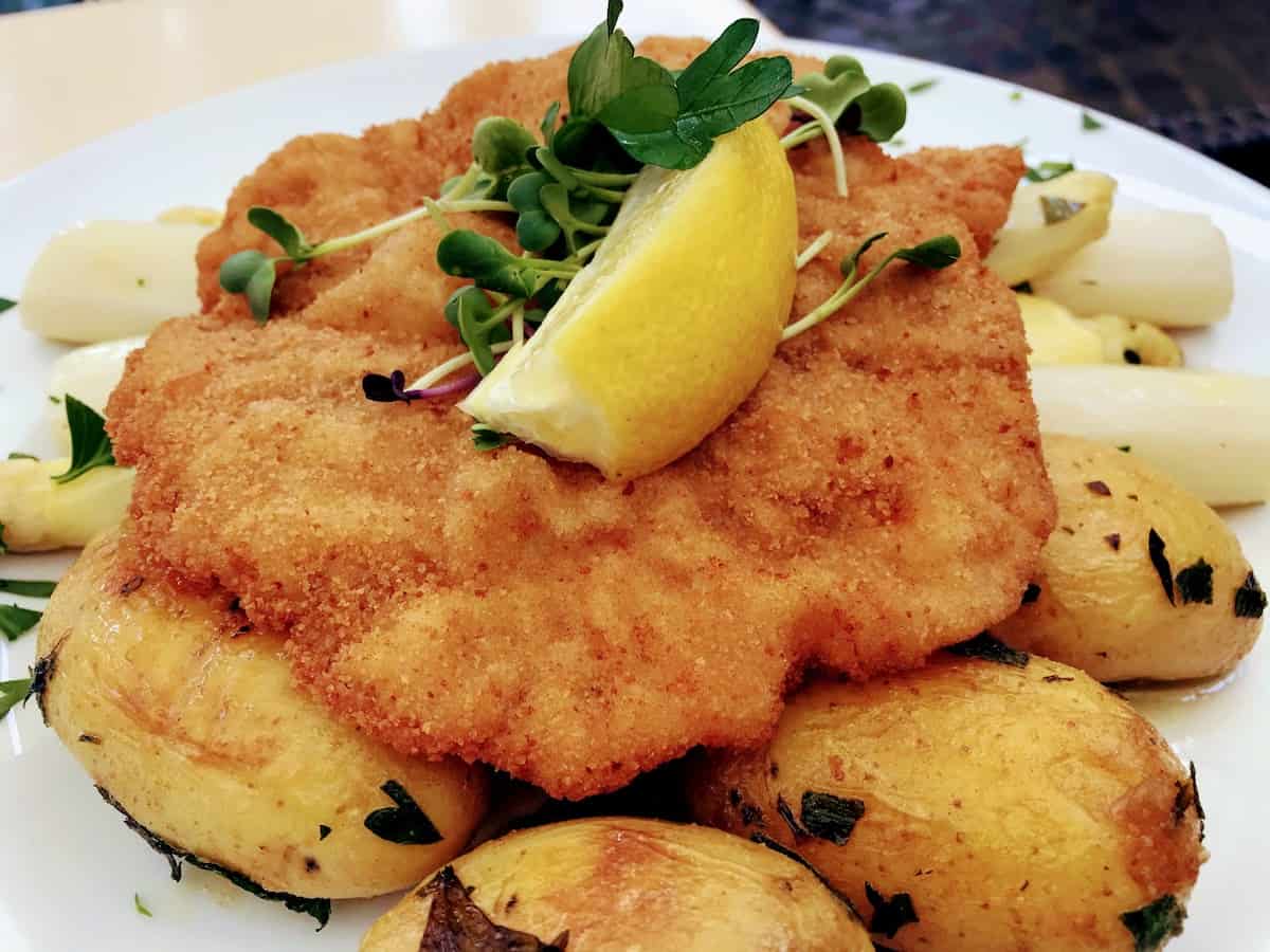Wiener schnitzel on top of seasonal white asparagus and potatoes at Hintz & Kuntz in Mainz, Germany