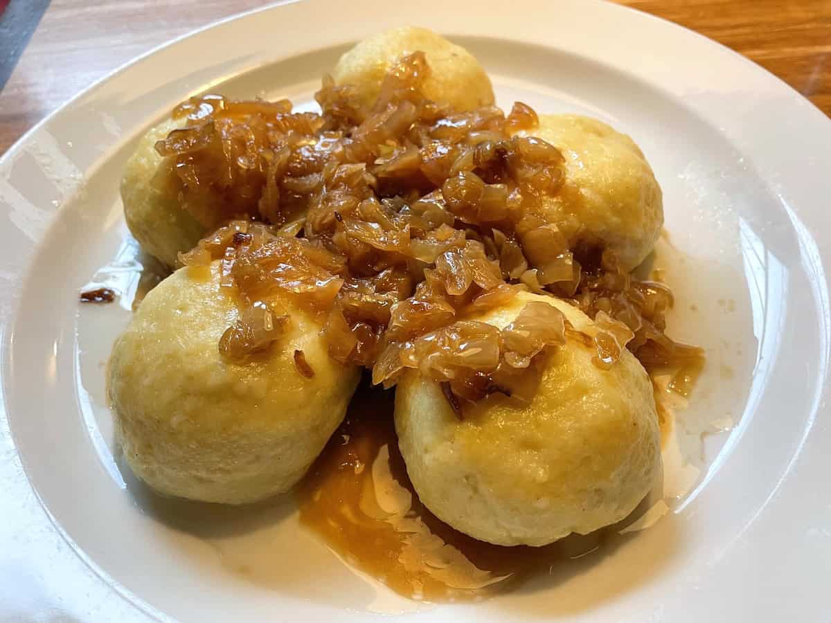 A typical Prague dish. Potato dumplings stuffed with smoked ham, covered with onions and cabbage