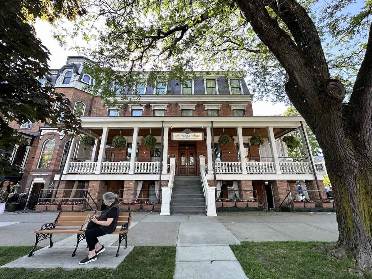 Wrap-around front porch of the Saratoga Arms Hotel on Broadway
