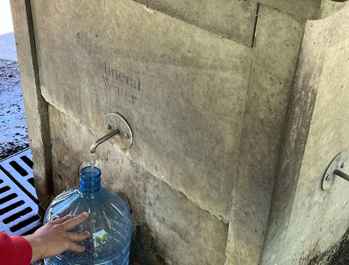Passerby filling his jug with mineral water at the Saratoga Spa State Park