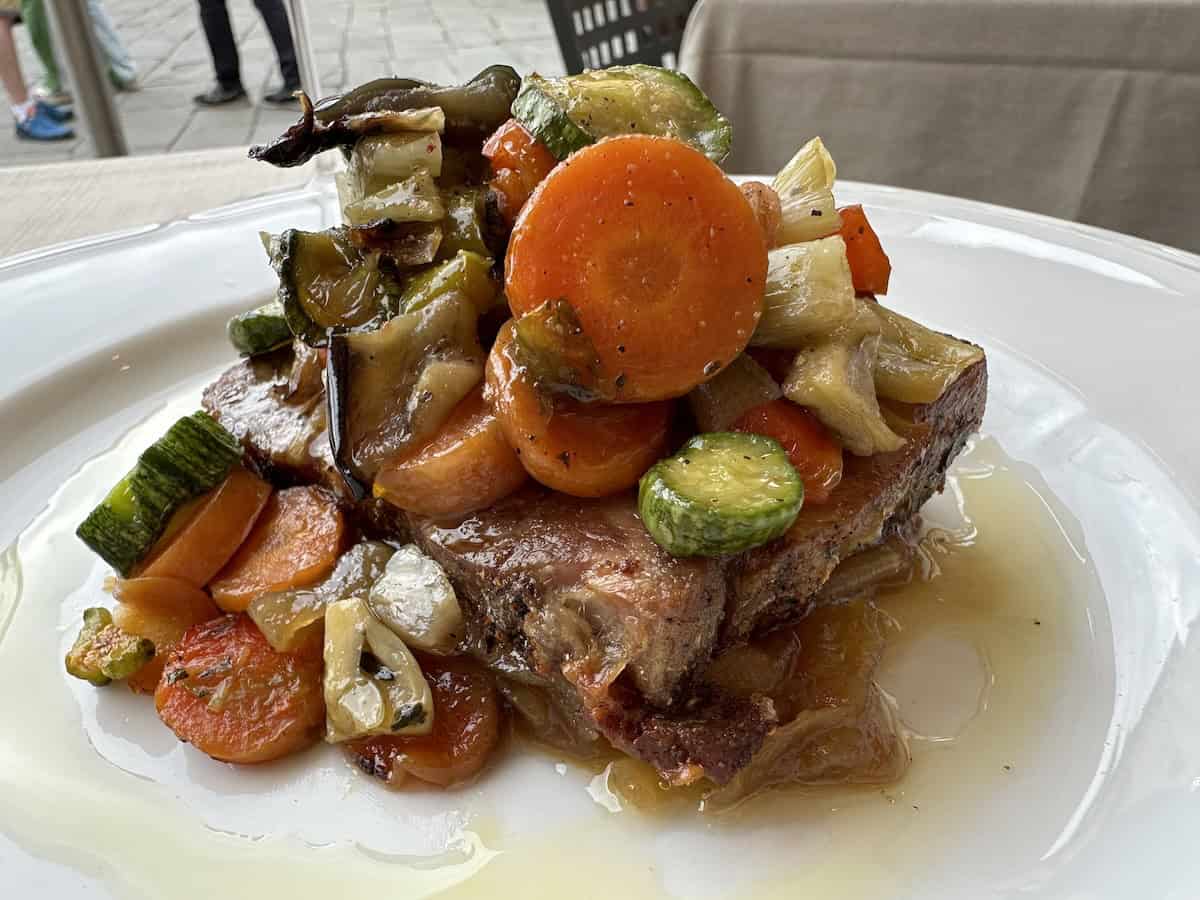 Varnelli Pork Neck with roasted vegetables and caramelized onions at Sotto Sotto (credit: Jerome Levine)