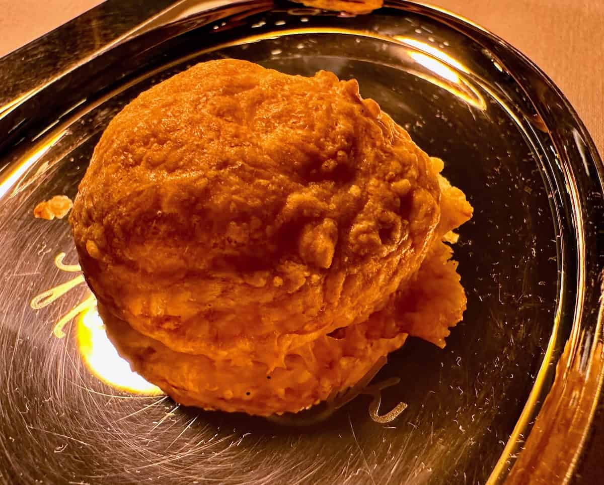 Dinner at Benoit: A soft, pillowy, freshly-baked Gougere (French cheese puff) Credit: Jerome Levine