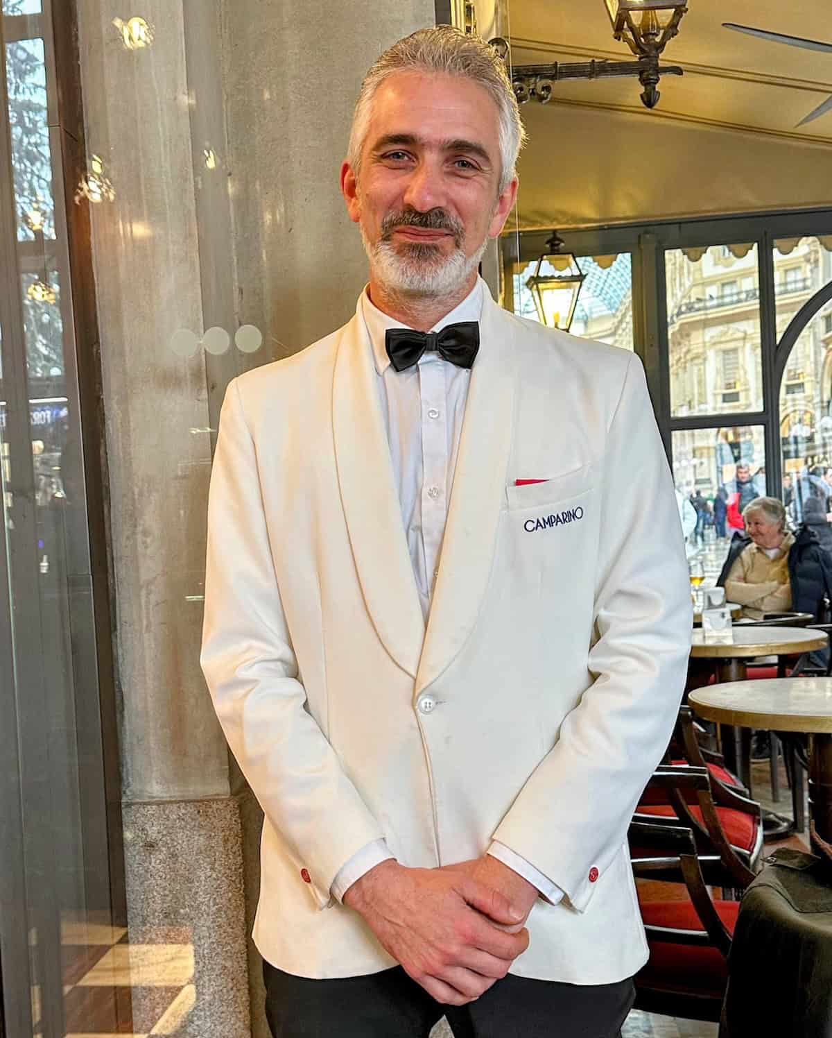 Food tastes better in Italy because of the professional service. Server at the Camparino Bar in Milan, which opened in 1915 and became the hub of the Milanese Aperitivo (credit: Irene S. Levine)