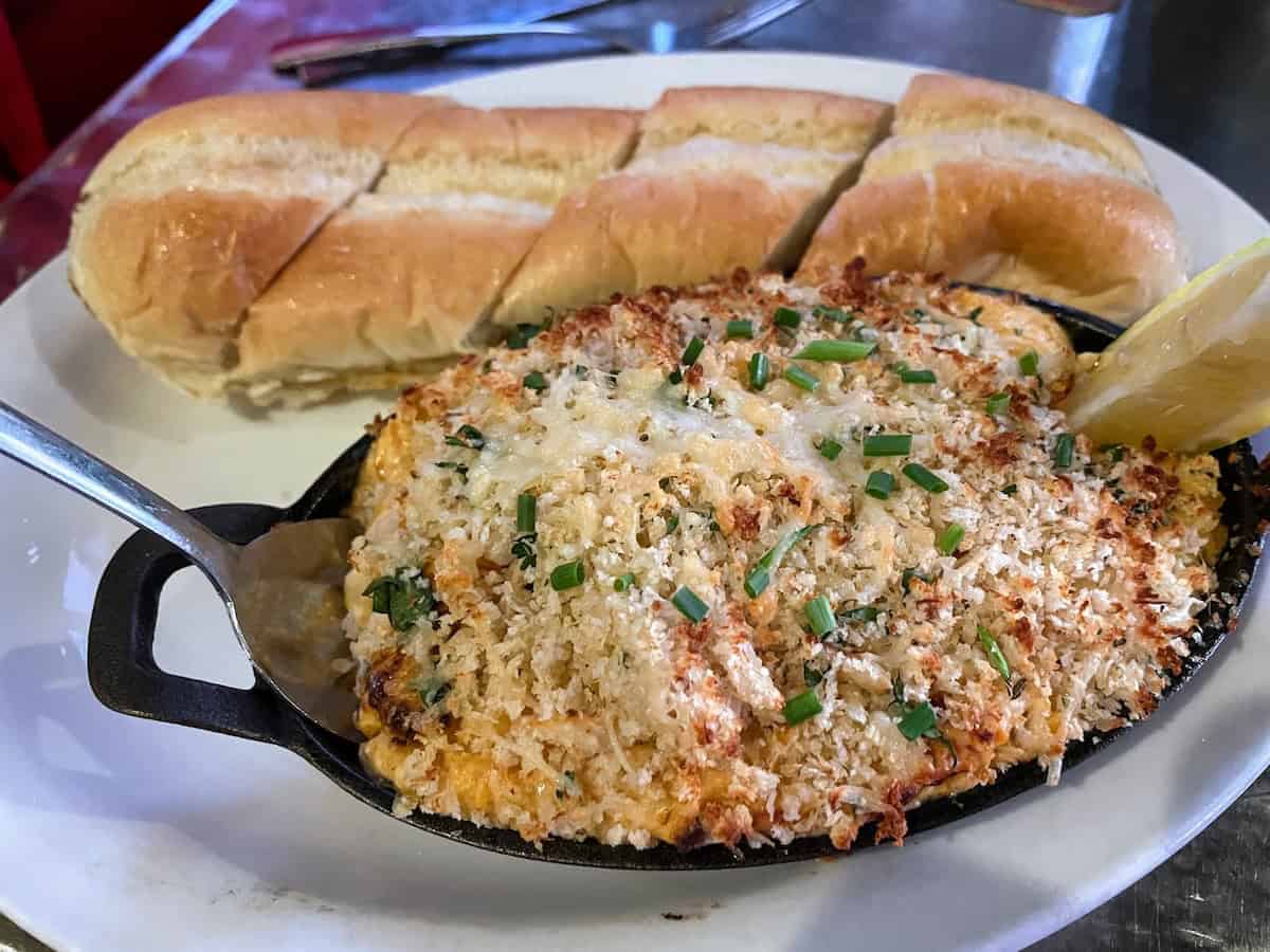 Eating alty Pelican’s signature dish, Blue Crab Dip on a culinary road trip (credit: John and Sandra Nowlan)