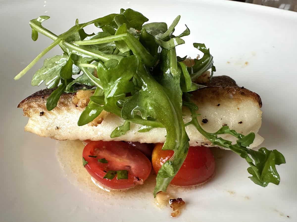 Halibut with arugula and tomatoes at The Chef&rsquo;s Table on Viking Neptune (credit: John and Sandra Nowlan)