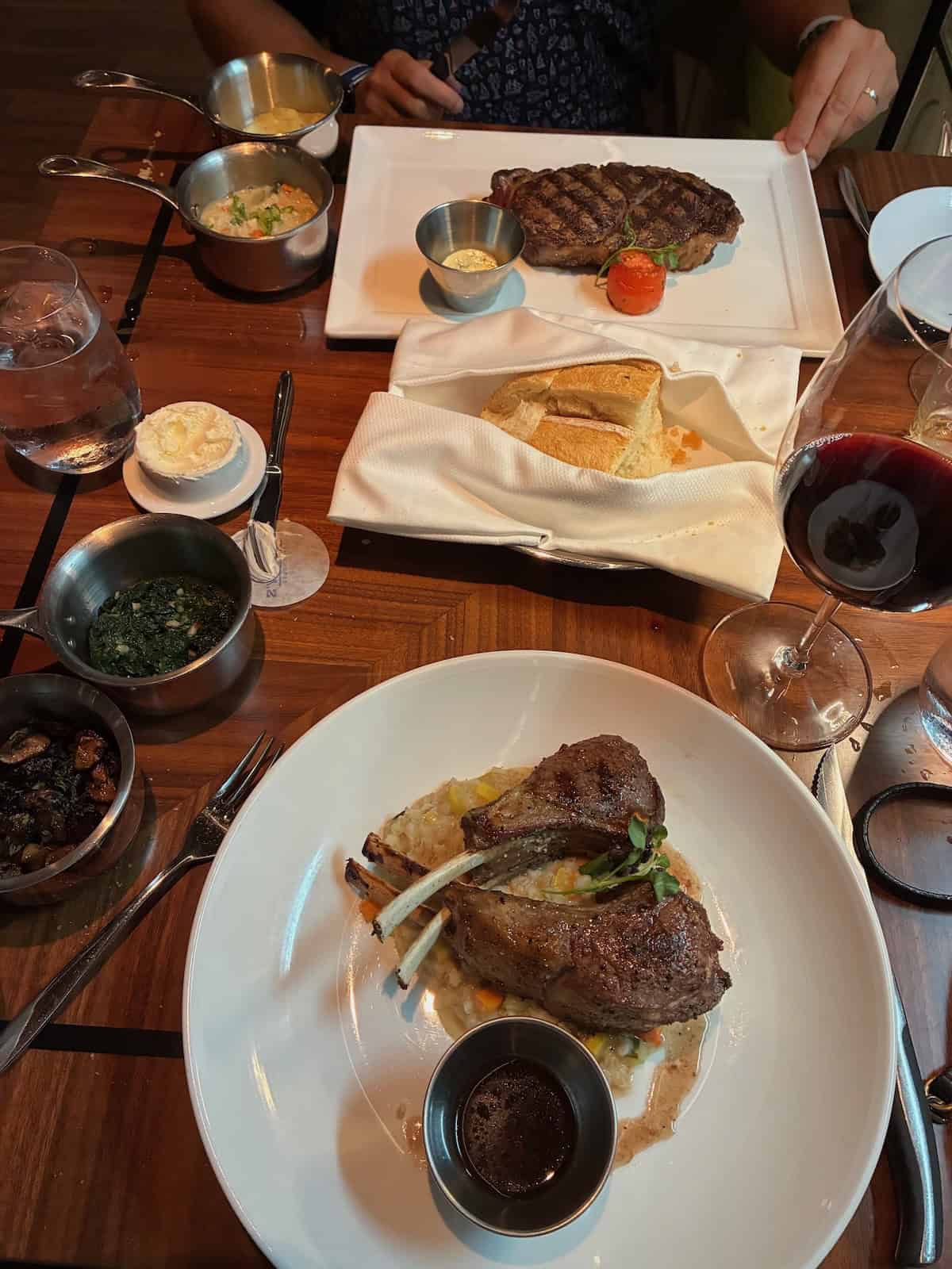 Savoring tender lamb chops and classic steakhouse sides at Cagney’s (credit: Ashley Fenton)