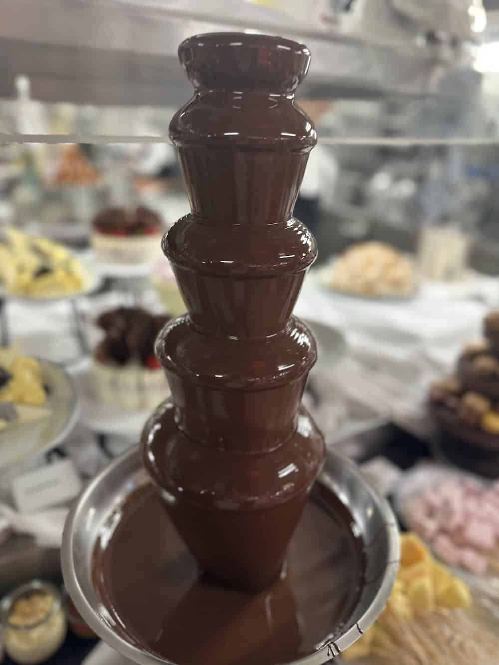A chocolate fountain besides the dessert display (credit: Irene S. Levine) 