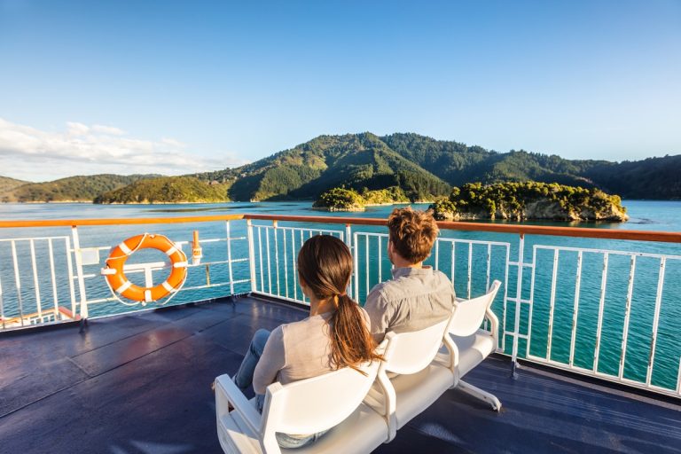 Travelers on a ferry boat in New Zealand (Adobe stock)