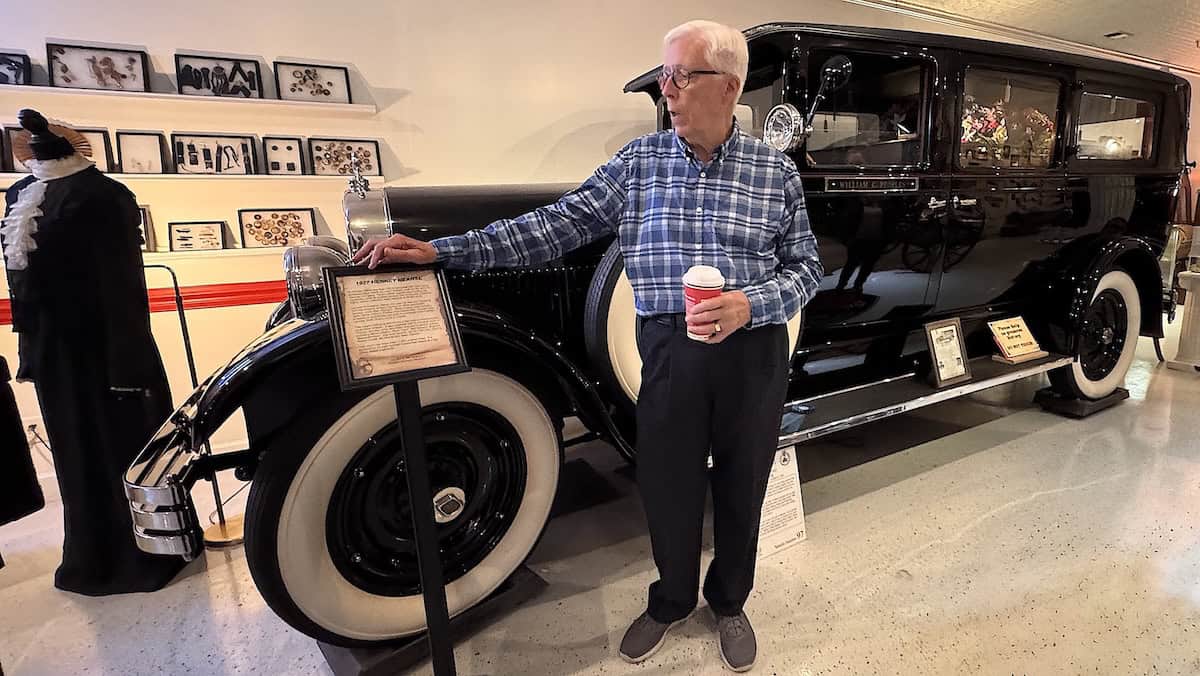 Bill with the 1927 Henney Hearse. In the background is a collection of mourning jewelry (credit: Jackie Sheckler Finch)